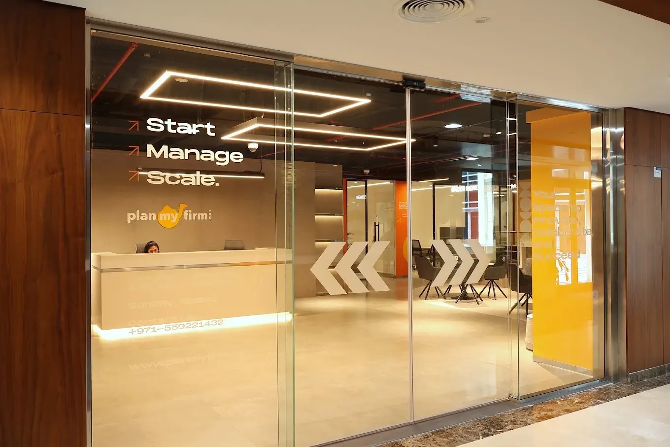 Glass entrance to PlanMyFirm showing Start, Manage, Scale