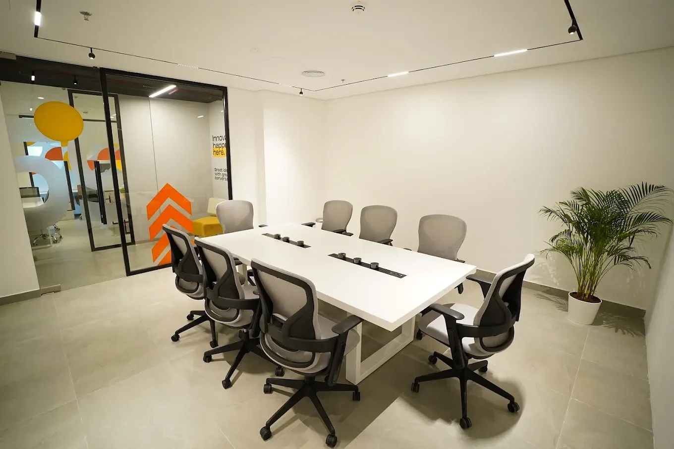 Boardroom seating eight with a white conference table