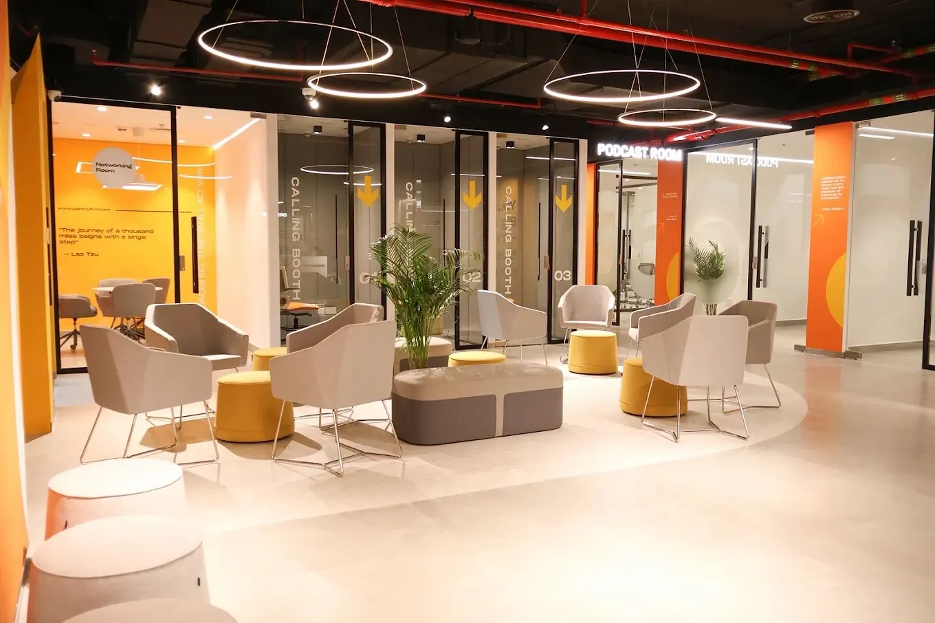 Networking lounge with calling booths and the podcast room behind